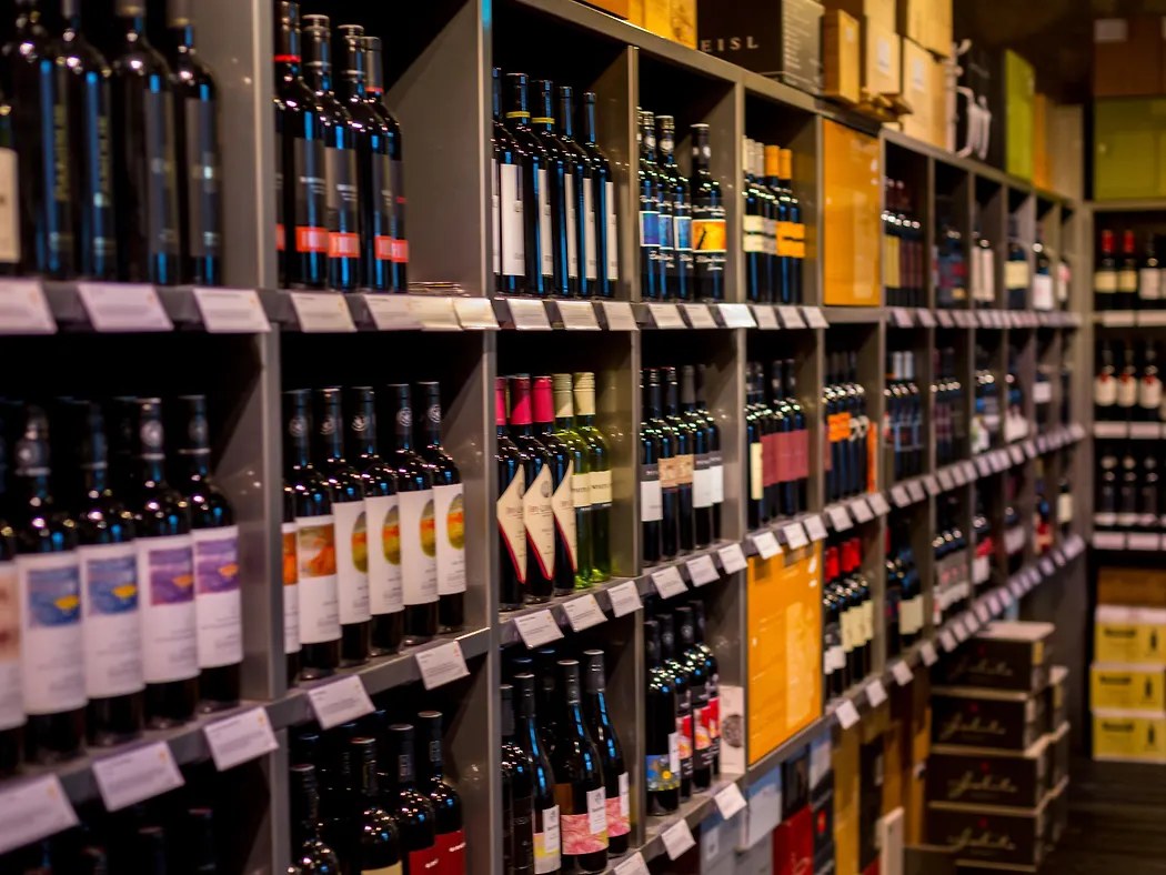 Rows of wine and spirits bottles on store shelves